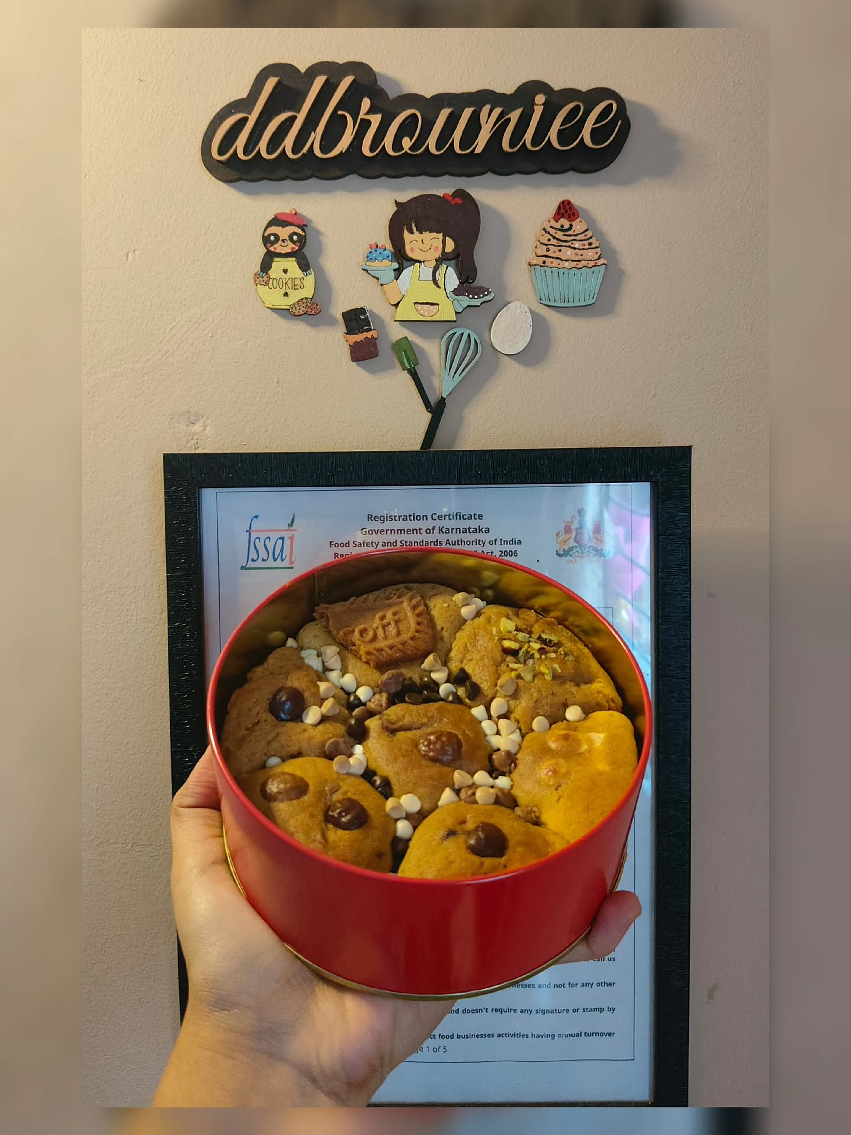 A signature red DD Browniee tin held up in the home bakery